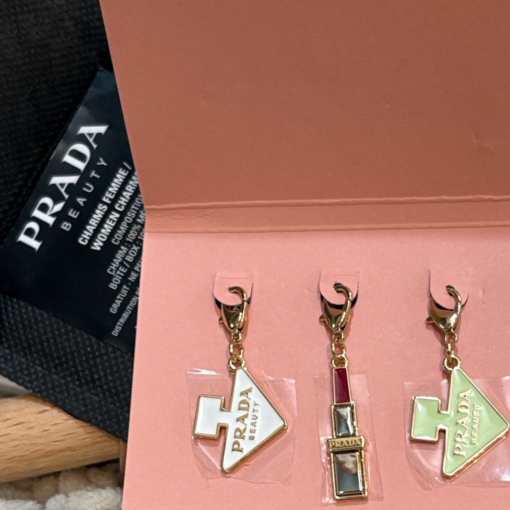 NWOT Prada Beauty Gold Tone Charm Trio